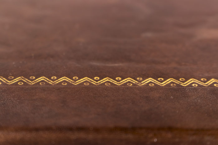 hexagonal side table brown leather gilt geometrical motifs