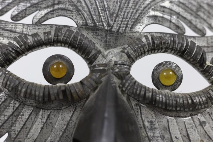 grotesque mask embossed silvered metal eyes