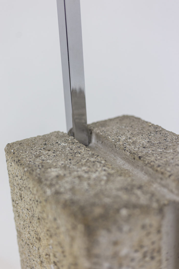 arc floor lamp in metal and chrome - detail of the base in stone