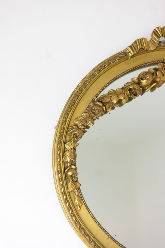 Miroir en bois doré à décor de guirlandes de fleurs et d'un ruban - miroirs