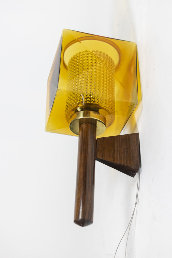 Wall sconce in rosewood and glass, rectangular in shape. Granite glass, translucent and yellow in color - other detail