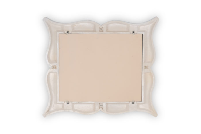 Art Deco style stucco mirror in “mustache” shape. 1990s. - dos