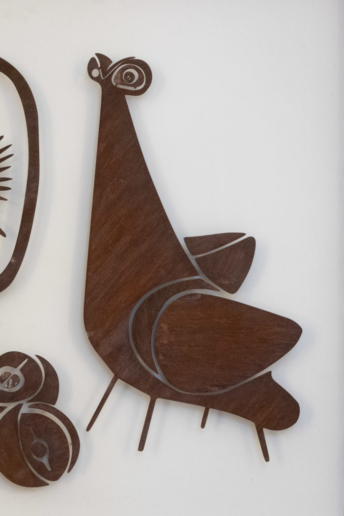 Decorative metal sign titled “Natumo”. Contemporary work.