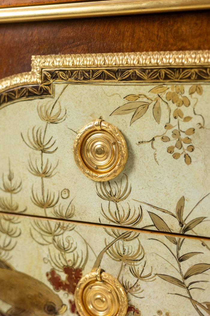 Empire style chest of drawers in lacquer, bronze and marble. Nineteenth century.