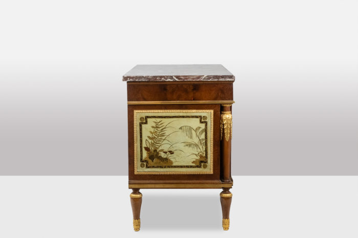 Empire style chest of drawers in lacquer, bronze and marble. Nineteenth century.